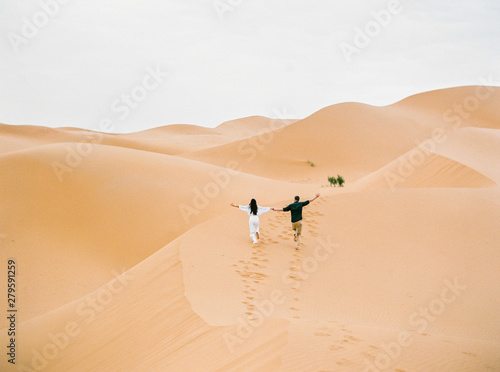 Loving couple in Sahara Desert.