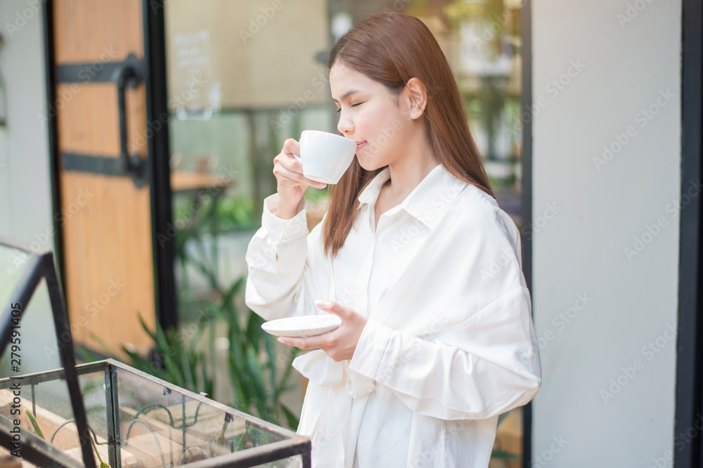 Asian Business woman is drinking coffee in the morning at coffee shop Asian Business woman is drinking coffee in the morning at coffee shop