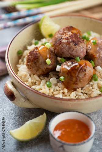 Close-up of rice with meatballs served in a bowl, selective focus, vertical shot