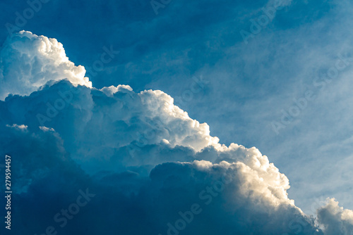 Blue sky with clouds and sun, sunset