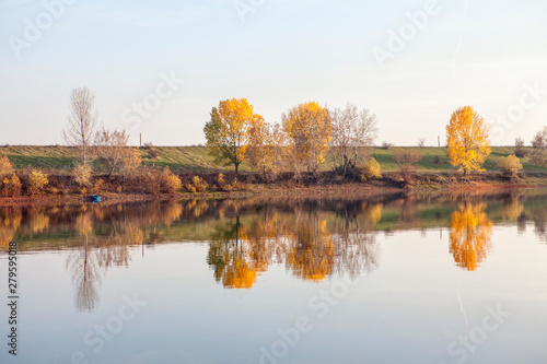 Idyllic autumn scenery with nature reflection in the water 