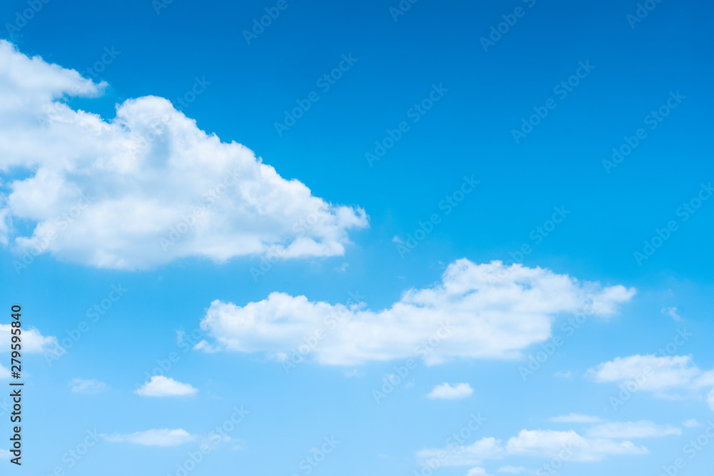 The blue sky with moving white clouds. The sky is a beautiful color shade suitable for use as a background image. The blue sky with moving white clouds. The sky is a beautiful color shade suitable for use as a background image.