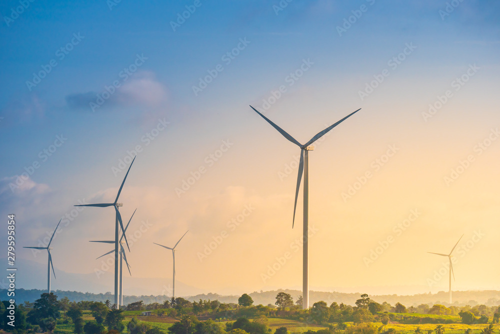 Obraz premium Green energy concept, eco power. Wind turbine located along the hill with the wind blowing all the time. Can produce renewable energy as well. Considered a clean energy.
