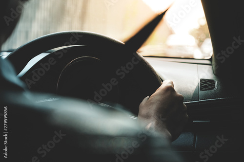 Hand's man holding steering wheel,on the way on travelling.