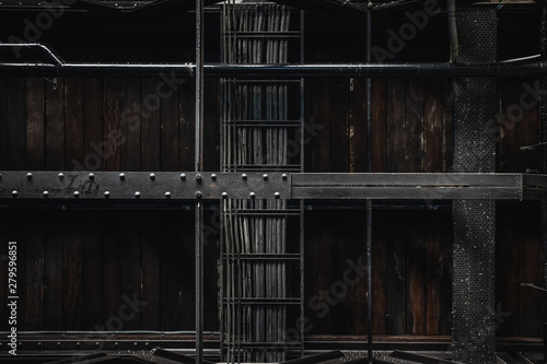 Industrial exposed ceiling with timber boards, steel beams and exposed wiring. Textured background graphic asset.
