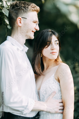 Happy couple outdoors at sunset. A stylish wedding in the European style of fine art.