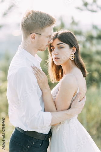 Happy couple outdoors at sunset. A stylish wedding in the European style of fine art.