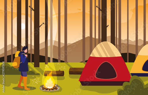 man camping campfire forest tent