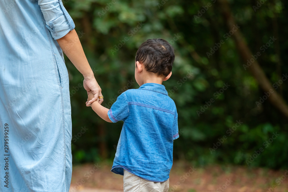 Happy mother and adorable little boy enjoying warm weather at beautiful park Happy mother and adorable little boy enjoying warm weather at beautiful park
