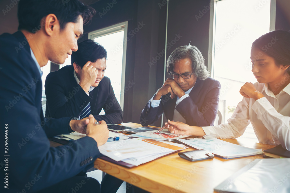 Image of business people hands working with papers at meeting. Businessman holding pens and holding graph paper are meeting to plan sales to meet targets set in next year. Image of business people hands working with papers at meeting. Businessman holding pens and holding graph paper are meeting to plan sales to meet targets set in next year.