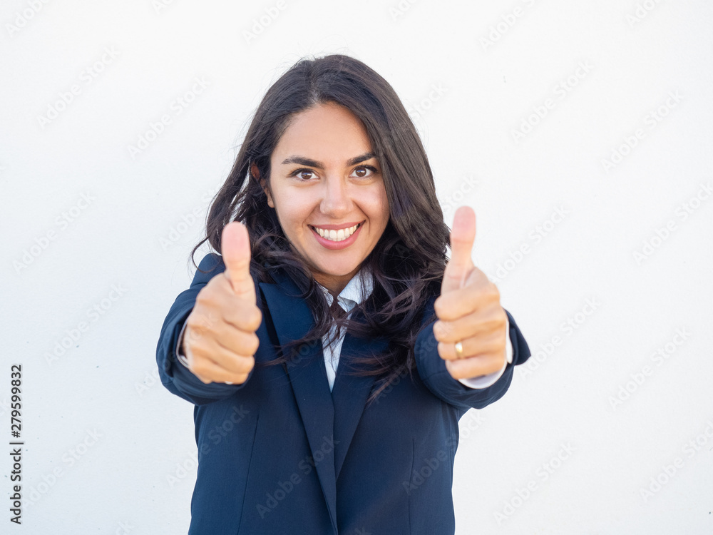 Smiling positive professional showing thumbs up with both hands. Happy beautiful young Latin woman in office suit making like gesture. Success concept Smiling positive professional showing thumbs up with both hands. Happy beautiful young Latin woman in office suit making like gesture. Success concept