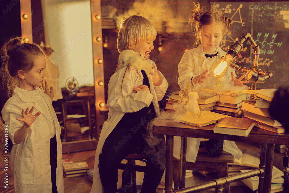 three children in white coats playing with rats in laboratory