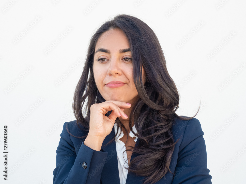 Pensive disappointed woman in office suit touching chin and looking away. Young beautiful business woman making skeptical grimace. Human emotions concept Pensive disappointed woman in office suit touching chin and looking away. Young beautiful business woman making skeptical grimace. Human emotions concept