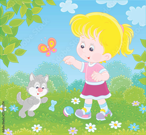 Smiling little girl playing with a small grey kitten among flowers on green grass of a lawn on a sunny summer day  vector illustration in a cartoon style