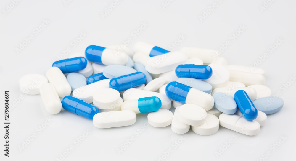 Pharmacy theme. Blue capsules and white antibiotic pills.