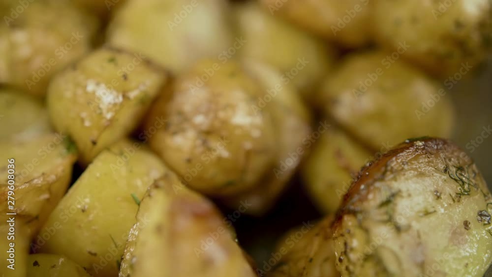 Fork pricks golden baked potato Fork pricks golden baked potato