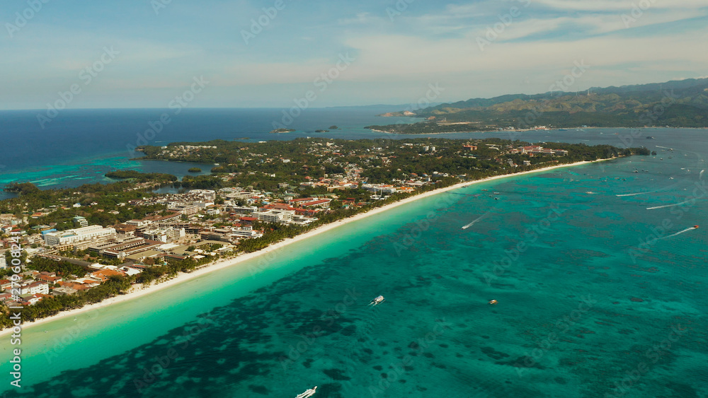 Aerial view of beautiful bay in tropical Island with white sand beach Boracay, Philippines. White beach with tourists and hotels. Tropical white beach with sailing boat.