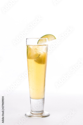 Lemonade with lime slice in tall glass isolated on white background
