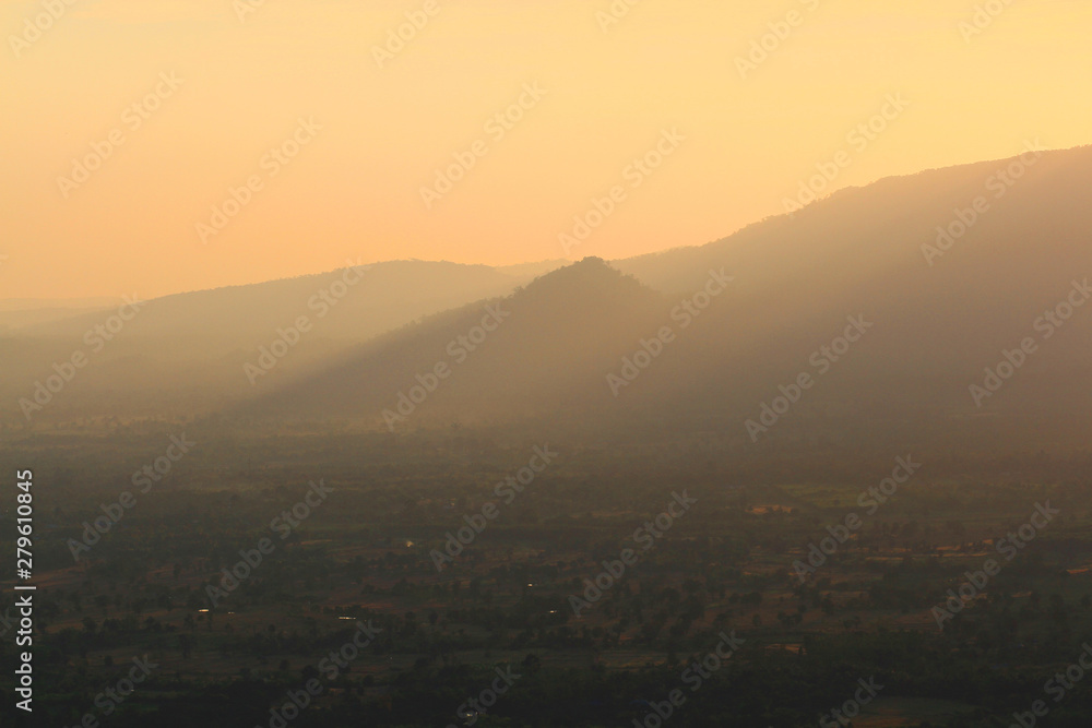 Beautiful landscape layers of mountain and Misty on hill valley in golden twilight of sunset at Thailand