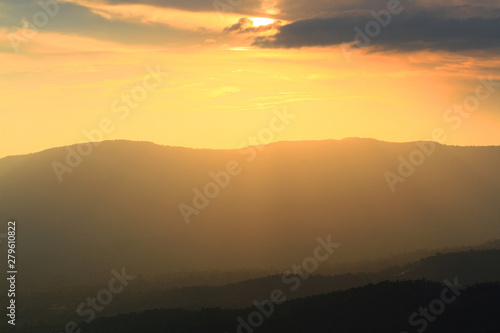 Beautiful landscape layers of mountain and Misty on hill valley in golden twilight of sunset at Thailand © cocorattanakorn
