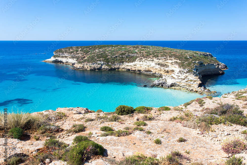 Lampedusa Island Sicily - Rabbit Beach and Rabbit Island Lampedusa “Spiaggia dei Conigli” with turquoise water and white sand at paradise beach. Lampedusa Island Sicily - Rabbit Beach and Rabbit Island Lampedusa “Spiaggia dei Conigli” with turquoise water and white sand at paradise beach.