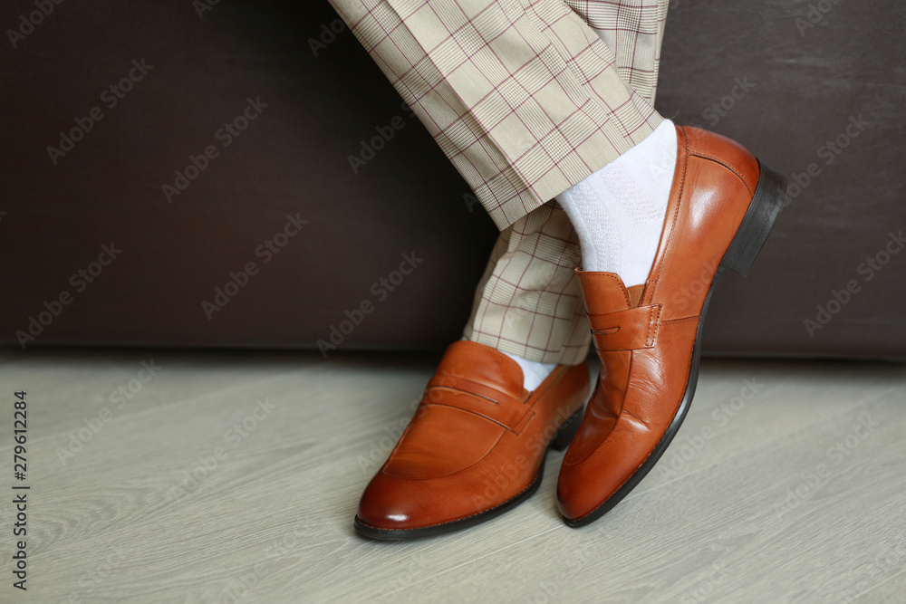 brown classic boots on the floor by the man brown classic boots on the floor by the man