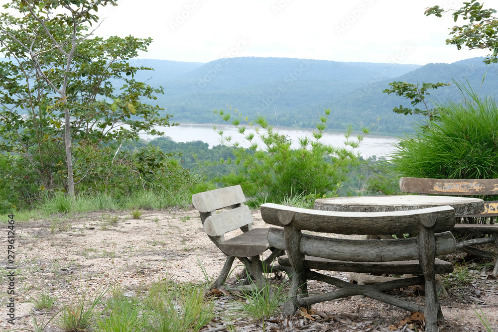 wooden bench on mountain hill with river view wooden bench on mountain hill with river view