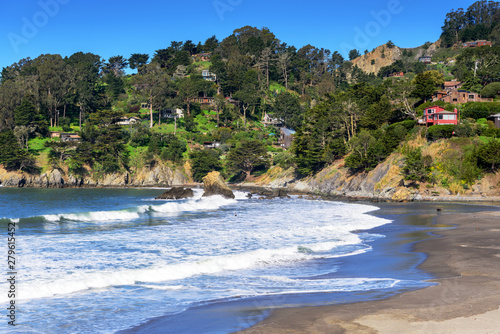 Panoramic view of ocean Wave breaking along Muir Beach with view of houses on the hill, California, San Francisco, USA photo