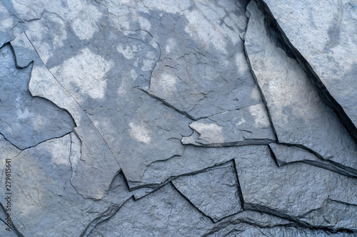 Natural background. Texture of wet cracked slate stone