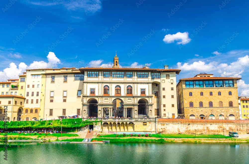 Museo Galileo museum, Gallerie degli Uffizi gallery and buildings on embankment promenade of Arno river in historical centre of Florence city, blue sky white clouds background, Tuscany, Italy