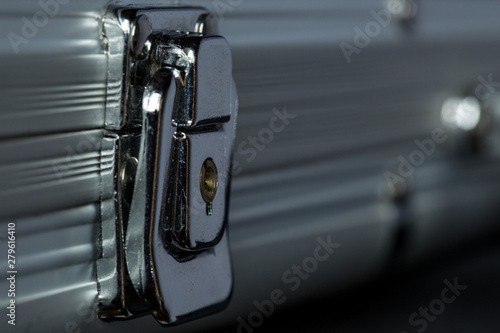 Extreme close-up of locked metal briefcase