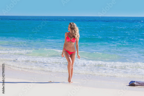Happy girl in bikini at seaside