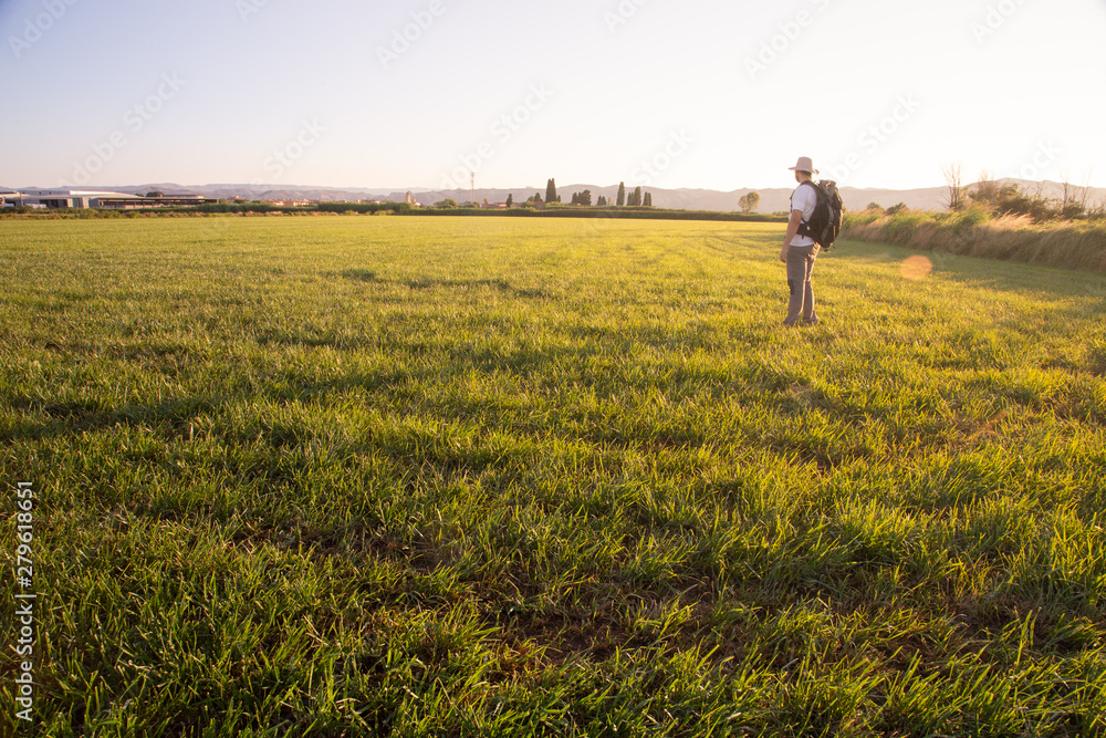 backpacker traveler walking at sunrise backpacker traveler walking at sunrise