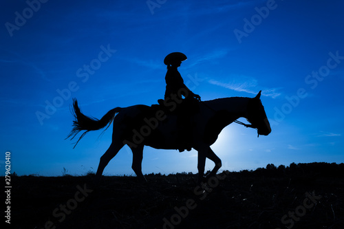 Silhouette cowgirl on horse at sunset in blue (10)