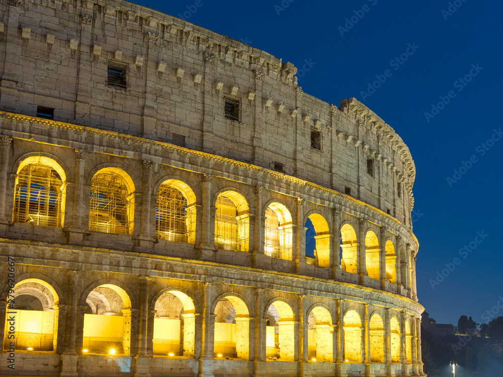 wall of Colosseum in night illuminating in Rome in Italy
