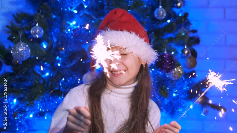 Girl dancing with a sparkler. Happy teenage girl on Christmas night with sparklers. Girl dancing with a sparkler. Happy teenage girl on Christmas night with sparklers.