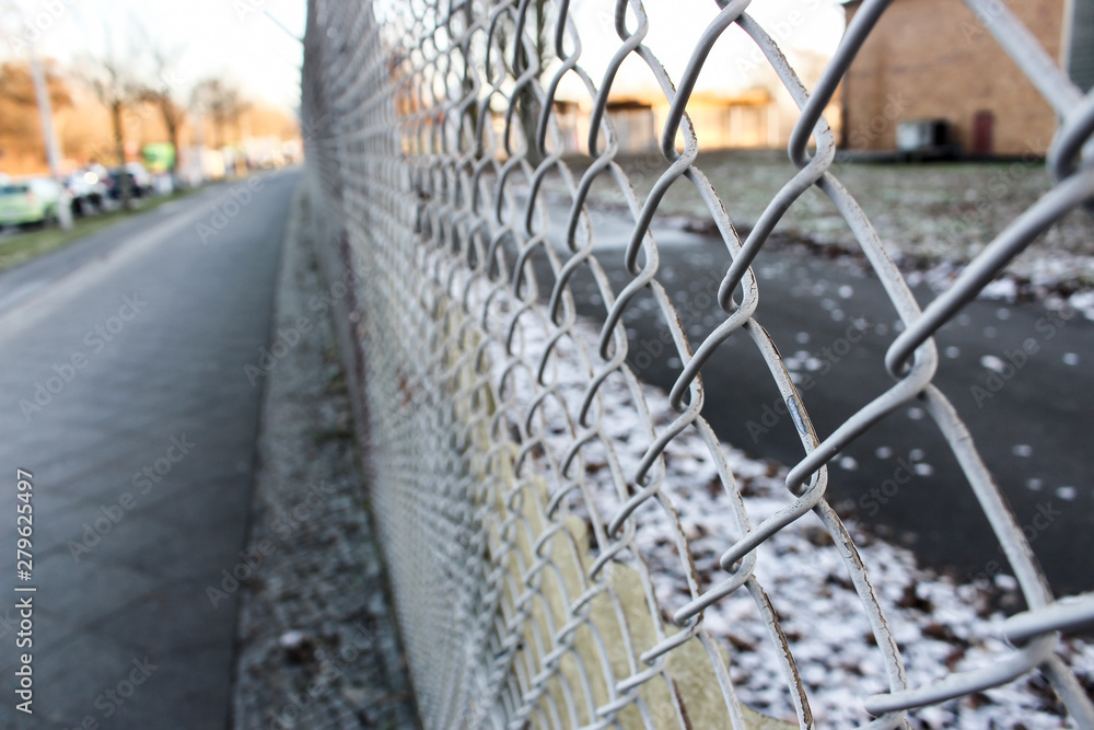 The close up of rusty wire fence with burred background in winter, Germany. The close up of rusty wire fence with burred background in winter, Germany.