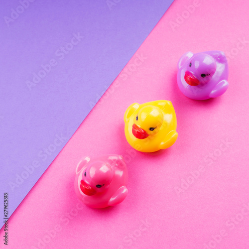 Colorful rubber ducks on geometry backdrop