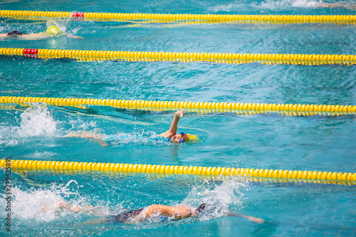 Athlete in freestyle swimming race in swimming pool