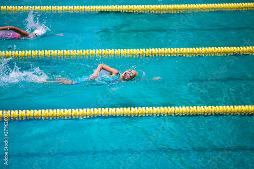 Athlete in freestyle swimming race in swimming pool