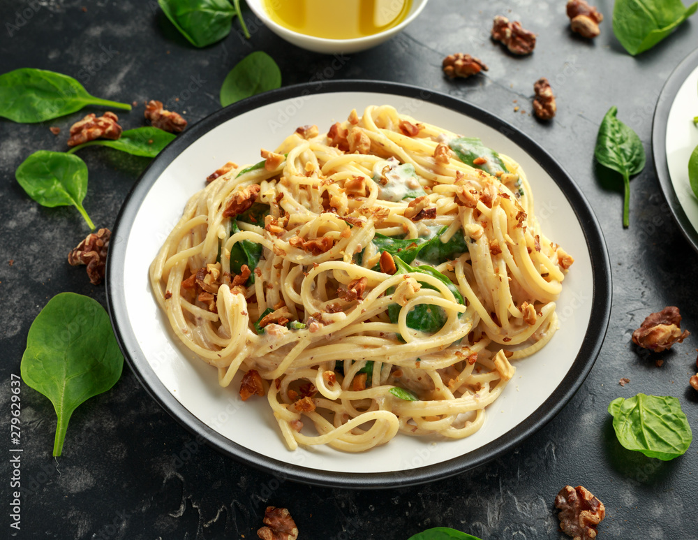 Pasta with roasted walnut, ricotta white pesto sauce, parmesan cheese and spinach