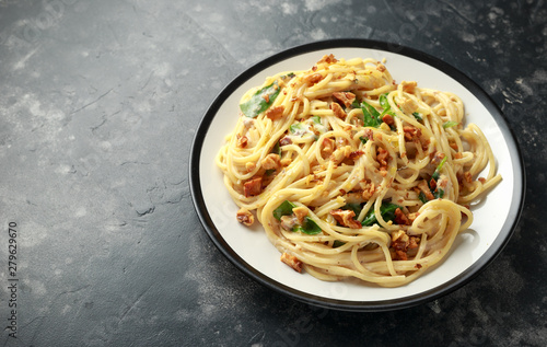 Pasta with roasted walnut, ricotta white pesto sauce, parmesan cheese and spinach