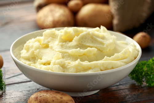 Quadro su tela Mashed potatoes in white bowl on wooden rustic table