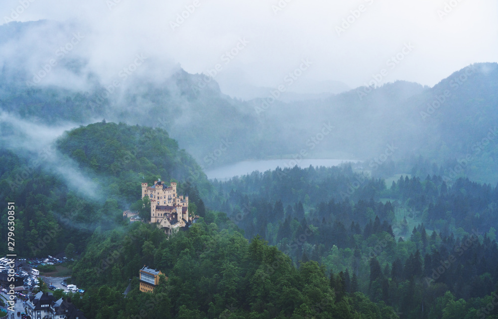 Panoramic pine forest and Hohenschwangau castle with foggy environment in Germany
