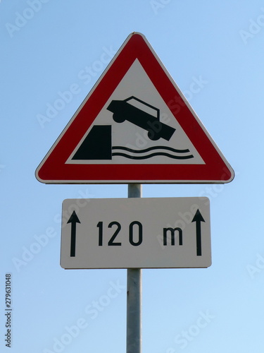 Traffic sign  riverbank falling car in water for 120m photo