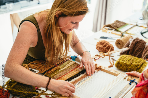 Attractive young woman learning to weave