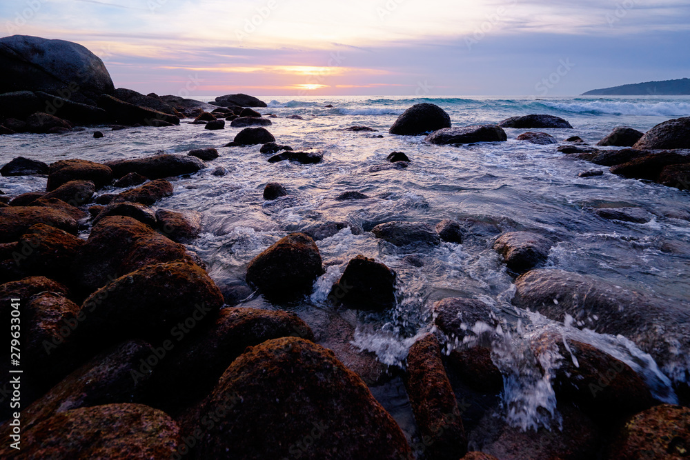Obraz premium Beautiful landscape with sea, stones and sunset sky.