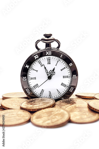 Pile of golden coins with pocket watch on white background.