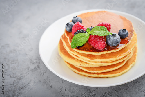 Pancakes with fresh berries and maple syrup