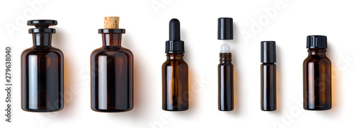 various amber glass bottles for cosmetics, natural medicine , essential oils or other liquids isolated on a white background, top view